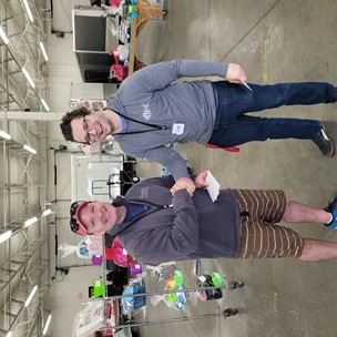 two people shaking hands in a warehouse