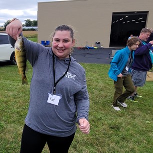 woman holding up a fish