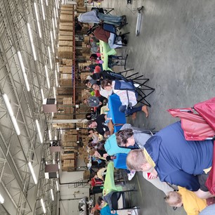 people at colorful tables in a warehouse