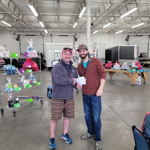two people shaking hands in a warehouse