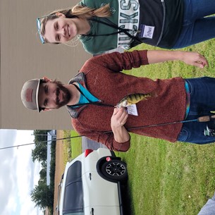 a couple holding up a fish